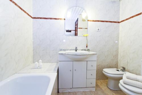a white bathroom with a sink and a toilet at MAEVA HomeStay by Turismar in Cambrils