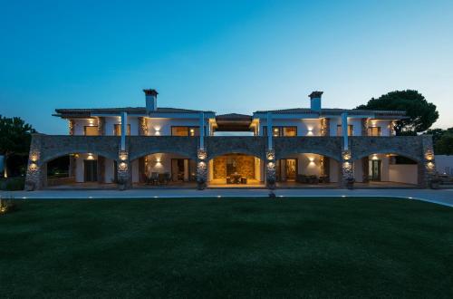 a large house with a lawn in front of it at Amelia Villa Collection in Arkítsa