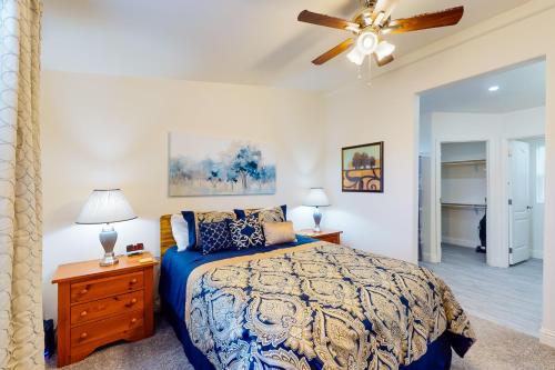 a bedroom with a bed and a ceiling fan at Apache Abode in Show Low