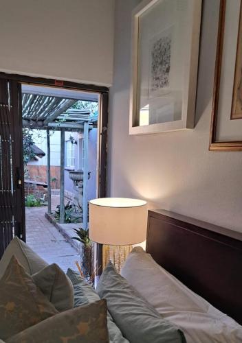 a living room with a couch and a lamp at No. Forty2 on President in Parys