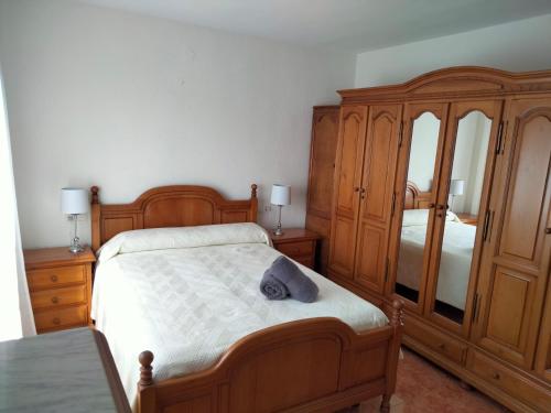 a bedroom with a bed and a dresser and mirror at APARTAMENTO PLAYA AZUL in Rincón de la Victoria