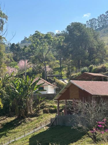 坎普斯杜若爾當的住宿－Recanto São Francisco，一座小房子,位于山丘上,树木繁茂