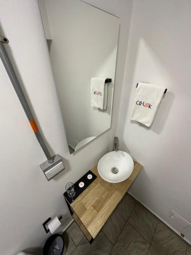 a bathroom with a white sink and a mirror at CoLinkHouse Hotel in Medellín