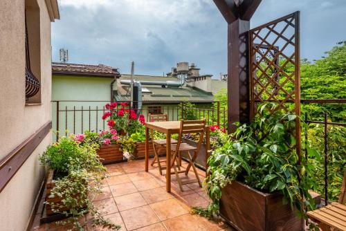 eine Terrasse mit einem Tisch und einigen Pflanzen auf einem Balkon in der Unterkunft Kazimierz Secret in Krakau