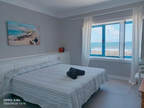 法馬拉的住宿－Casa Manrique，一间卧室设有一张床,享有海景
