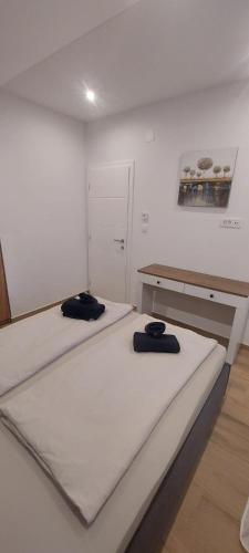 a room with two beds and a desk at Marina 2 in Sesvete