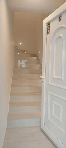 a hallway with a door and stairs with a van at Marina 2 in Sesvete