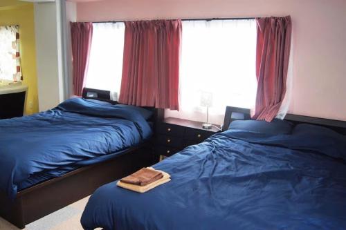 a bedroom with two beds and a window at Space Air Building 3F - Vacation STAY 11441 in Tokyo