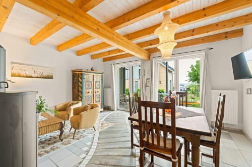 a living room with a wooden ceiling and a table and chairs at Plau Lagoons in Plau am See