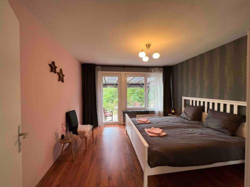 a bedroom with a bed and a television in it at Platell Ferienhäuser Harz Wieda in Walkenried