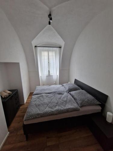 a bedroom with a bed and a window at Apartmán Anežka 3 s vířivou vanou in Jičín