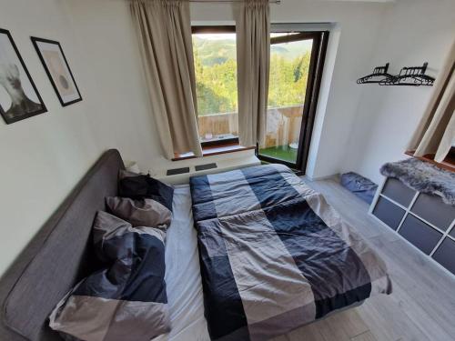 a bedroom with a bed and a window at Appartement 214 in Bad Goisern in Bad Goisern