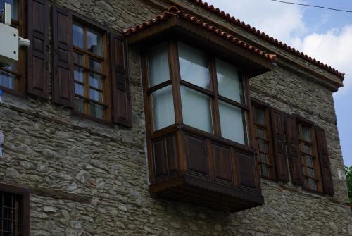 a window on the side of a stone building at Birgi Hotel Saliha Hanim Tas Konak in Birgi