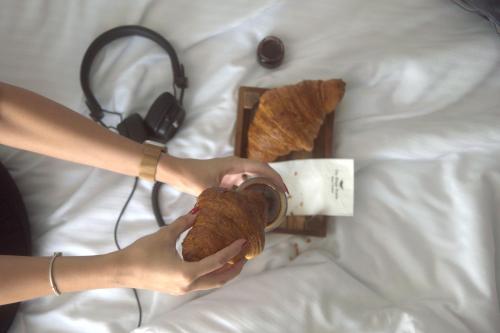 a person holding a teddy bear on a bed at The Wings Hotels Neva Palas in Ankara