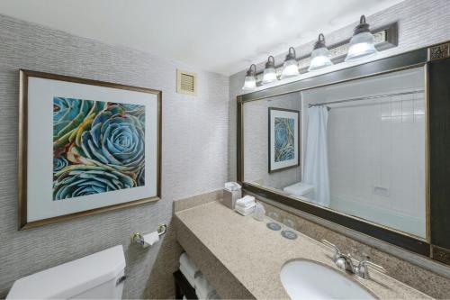 a bathroom with a sink and a large mirror at The Westin San Antonio North in San Antonio