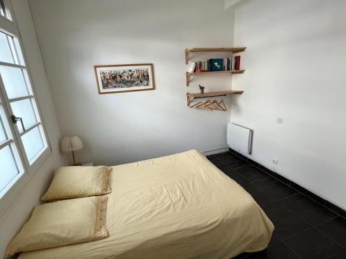 1 dormitorio con cama y ventana en La terrasse, en Frontignan