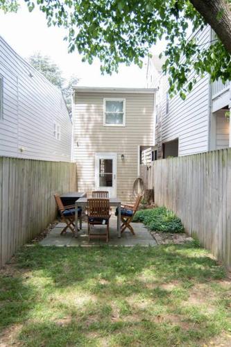 a backyard with a table and chairs and a fence at Cozy 2br home w/ parking in downtown Annapolis in Annapolis