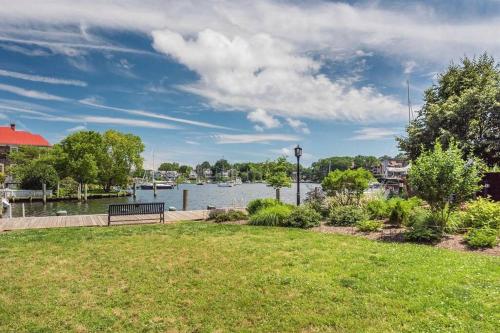 a park with a bench next to a body of water at Cozy 2br home w/ parking in downtown Annapolis in Annapolis