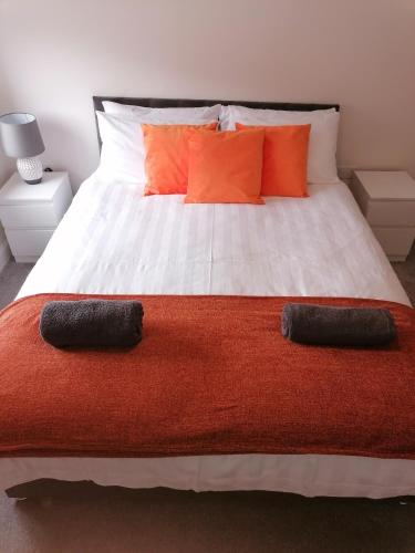 a bedroom with a large bed with two pillows on it at Apollo Avenue Apartment in Stony Stratford