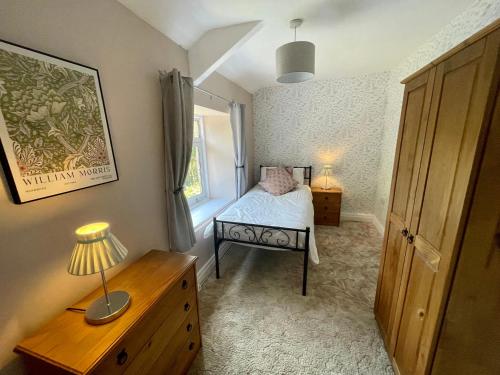 a small bedroom with a bed and a window at Joyces Cottage, 2 Brown Hill in Richmond