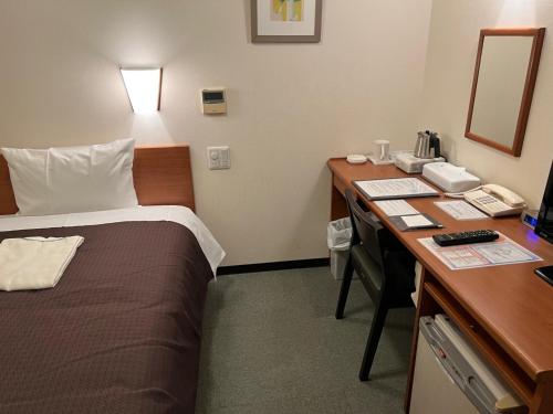 a hotel room with a bed and a desk at Anan Plaza Hotel - Vacation STAY 54404v in Anan