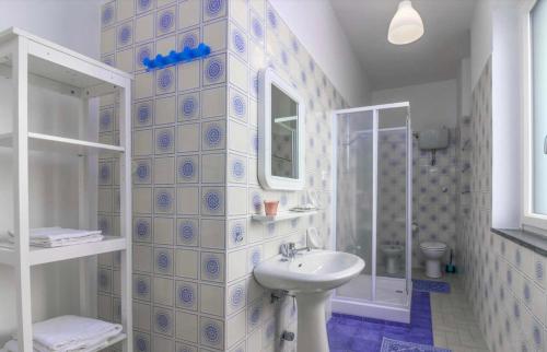 a white bathroom with a sink and a shower at Casa Mansi in Scala