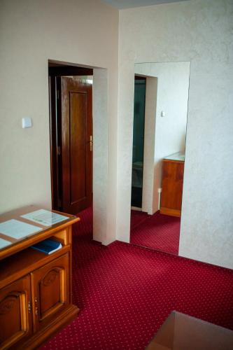 an empty room with a wooden desk and a door at Hotel Bavaria in Craiova