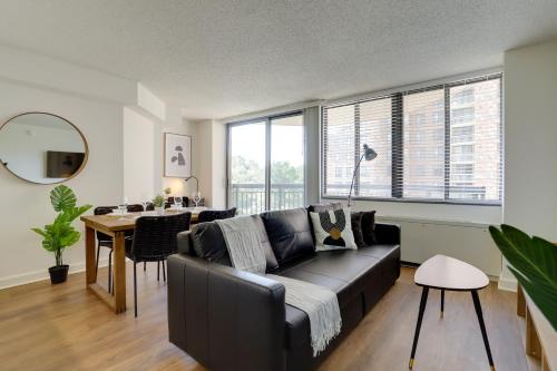 a living room with a black couch and a table at Unique Luxury Apt with Rooftop @Pentagon City in Arlington