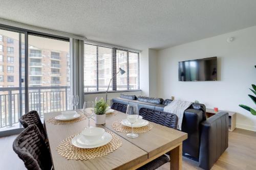a dining room with a table and a couch at Unique Luxury Apt with Rooftop @Pentagon City in Arlington