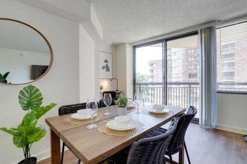 a dining room with a table with chairs and a mirror at Unique Luxury Apt with Rooftop @Pentagon City in Arlington