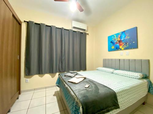 A bed or beds in a room at Apto charmoso e espaçoso no Centro, térreo com 2 Quartos ArCond WiFi HomeOfice Cozinha e Garagem