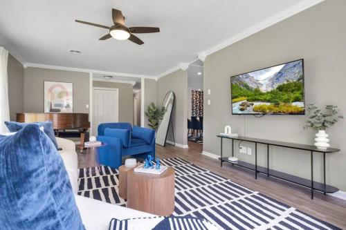 a living room with a couch and a ceiling fan at Cozy - Organic Modern - Bungalow - FSU in Tallahassee