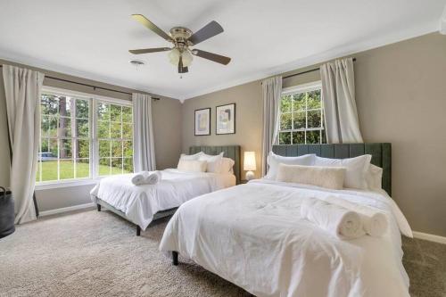 a bedroom with two beds and a ceiling fan at Cozy - Organic Modern - Bungalow - FSU in Tallahassee