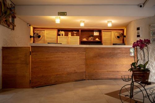a bar in a room with wooden walls at Porto Pacuíba Hotel in Ilhabela