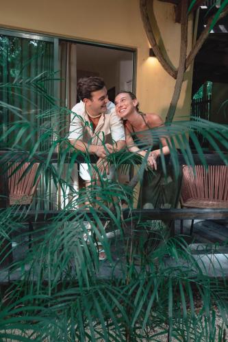a man and a woman sitting on a bench at Terasu Riviera Maya Hotel & Spa, en Xcaret in Playa del Carmen