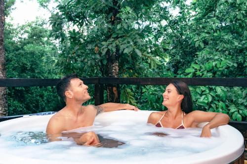 a man and a woman sitting in a hot tub at Terasu Riviera Maya Hotel & Spa, en Xcaret in Playa del Carmen