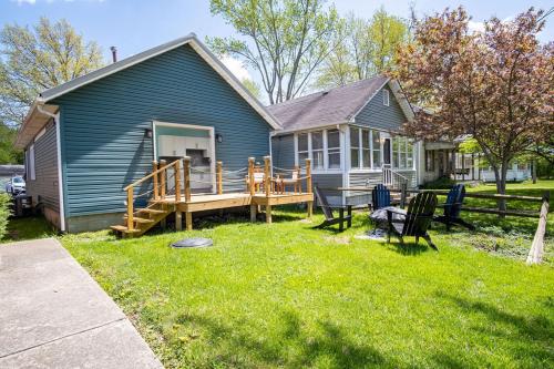 a blue house with a porch and a deck at Buckeye Lake Cottage in Hebron