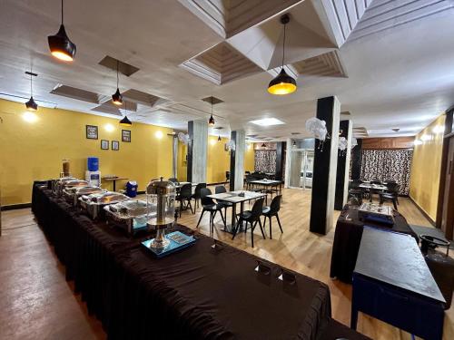 a restaurant with tables and chairs in a room at New Hotel Suhail in Hyderabad