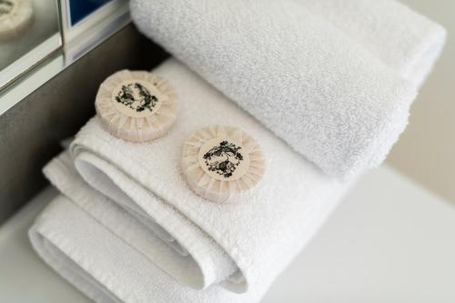 a pile of towels sitting on top of towels at Waikanae Beach TOP 10 Holiday Park in Gisborne