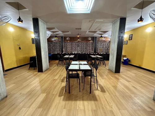 a restaurant with tables and chairs in a room at New Hotel Suhail in Hyderabad