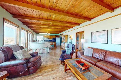 a living room with leather couches and a table at Sea Mist in Rockaway Beach