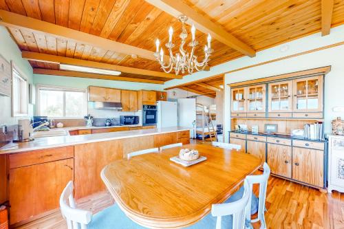 a large kitchen with a wooden table and chairs at Sea Mist in Rockaway Beach