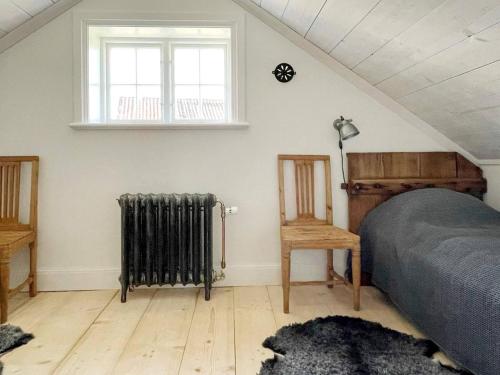 a bedroom with a bed and a radiator and a window at 4 star holiday home in Mellösa-By Traum in Mellösa