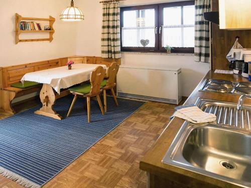 a kitchen with a table and a sink and a kitchen sidx sidx sidx at Apartment in Neuschönau near Bavarian Forest in Neuschönau