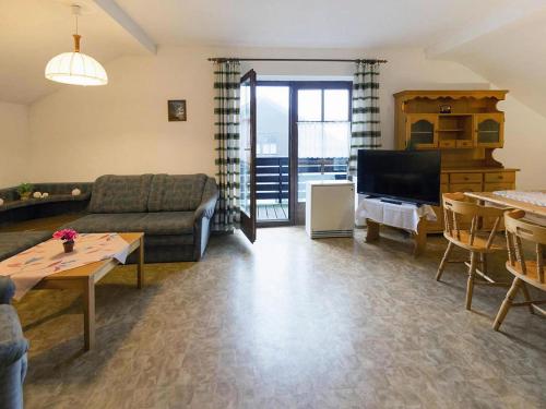 a living room with a couch and a tv at Apartment in Neuschönau near Bavarian Forest in Neuschönau