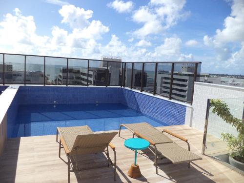a balcony with a swimming pool on top of a building at Compact Tambaú 408 in João Pessoa