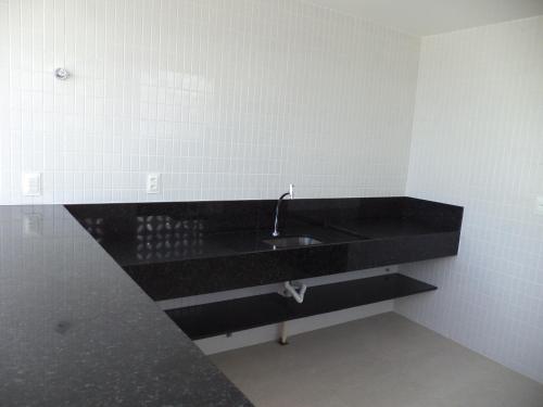 a bathroom with a black counter and a sink at Compact Tambaú 408 in João Pessoa