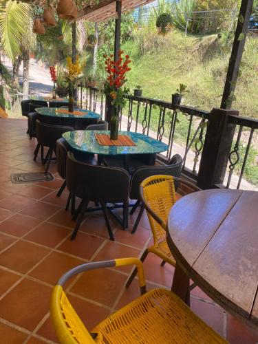 a patio with tables and chairs and tables and chairs at Oak Tree house in Guatapé