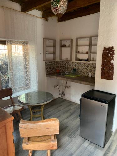 a kitchen with a table and a table and chairs at Eco cabaña in Tepoztlán