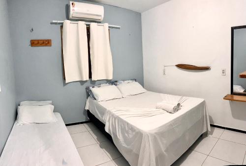 a hospital room with two beds and a fan at Pousada Apart Amor de Jeri in Jericoacoara